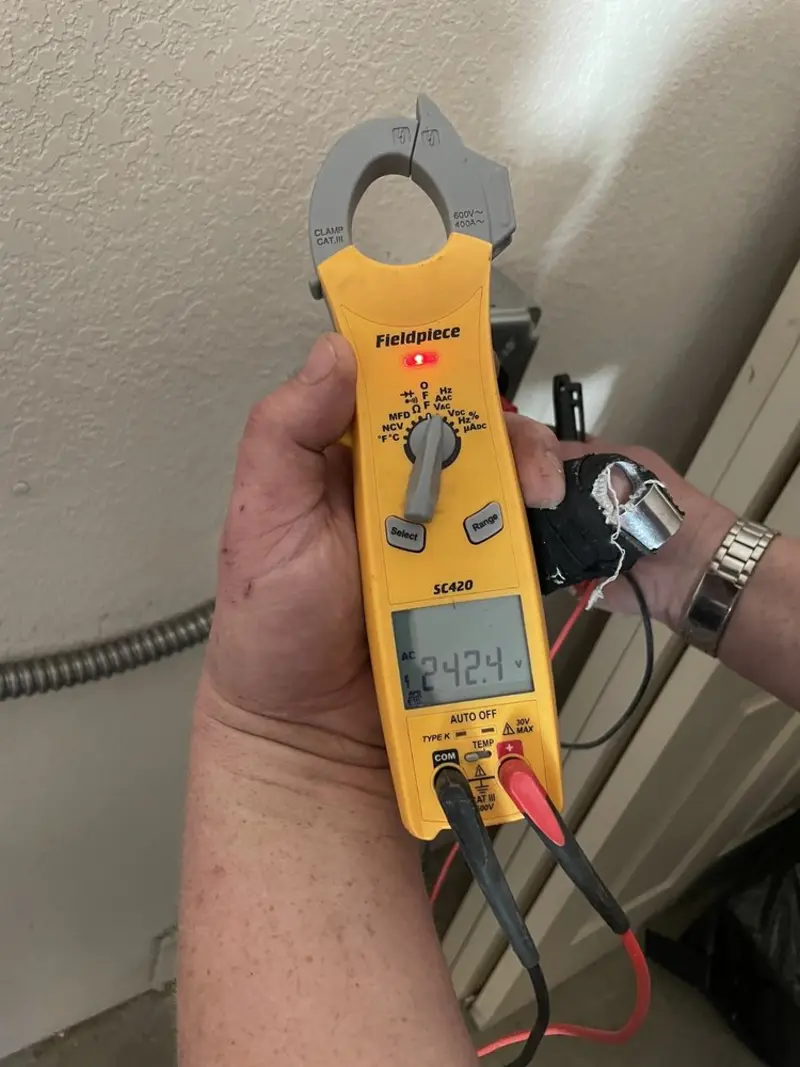 Voltage testing with clamp meter during Electrical Installation Services in Stanford